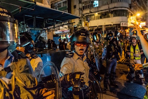 Riot police point pepper spray in the direction of protesters during clashes in Sham Shui Po on August 29, 2019 in Hong Kong, China. 