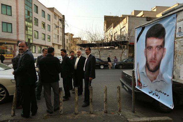 Male family members and mourners on the street outside the mosque where the memorial service was held.