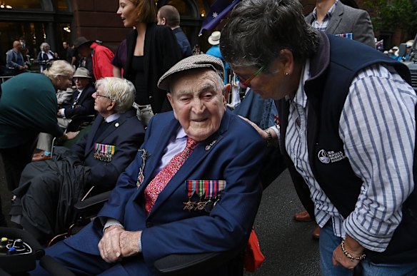 World War Two veteran Gordon Richardson aged 99 years old (2nd from right) talks to his daughter Lyn Whitlam (right) as they wait to March in the ANZAC Day march in Sydney.
