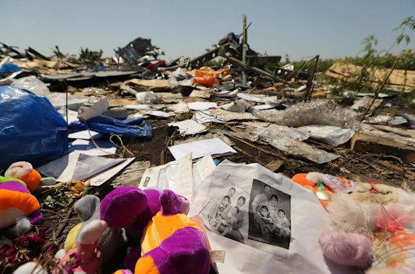 Photos and teddy bears lay at one of the sites near the front section.