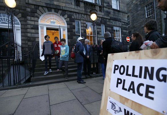 Young voters leave a polling station in Charlotte Square, Edinburgh.