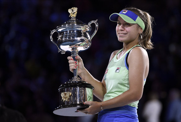 A smiling Sofia Kenin holds the Daphne Akhurst Memorial Cup after defeating Spain's Garbine Muguruza in the Australian Open final on Saturday night.