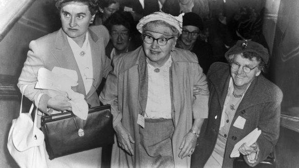 Mrs Melville, centre, arrives at the conference at the Trades Hall in Sussex Street, Sydney on 21 April, 1956.