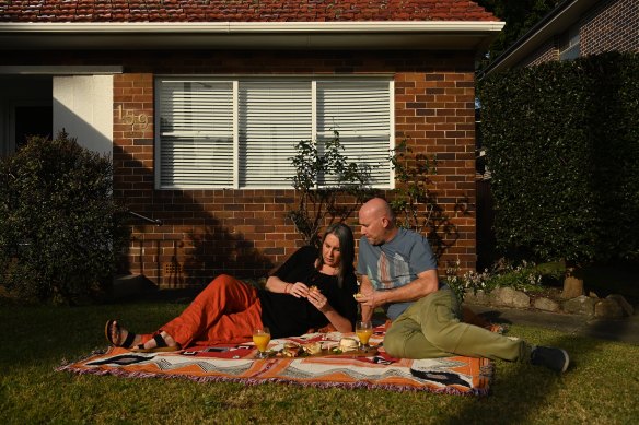 Nerida Walters and her husband Steve Welch in the front yard of their Maroubra home.