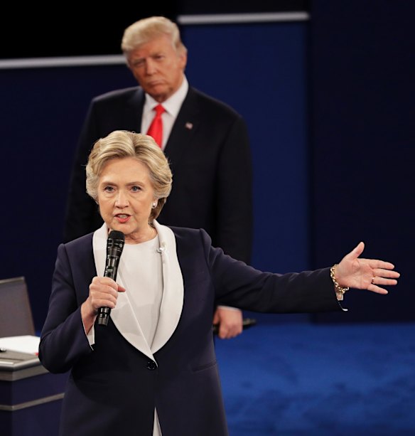 Republican presidential nominee Donald Trump listens to Democratic presidential nominee Hillary Clinton.
