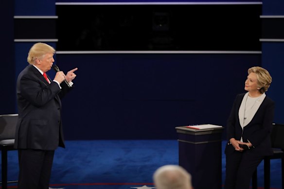 Republican presidential nominee Donald Trump points toward Democratic presidential nominee Hillary Clinton as he answers a question.