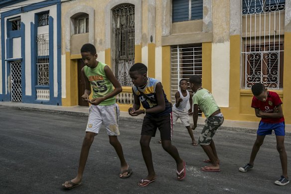 Boys play marbles near the Latinoamericano stadium.