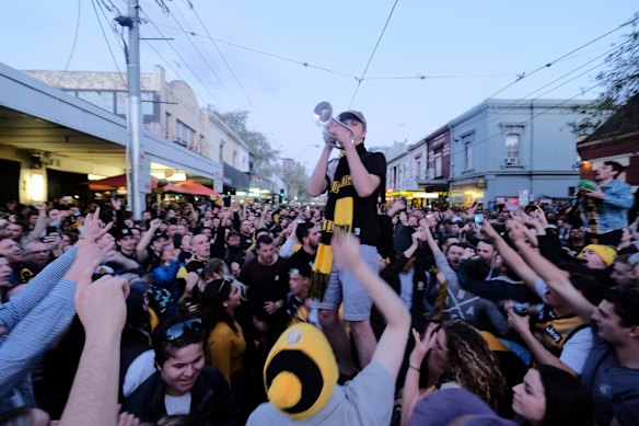 Richmond supporters celebrating their teams win over Adelaide during the AFL Grand Finals in Swan st Richmond.  Photo Luis Enrique Ascui