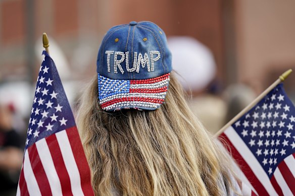 A supporter of President Donald Trump attends a rally outside the Maricopa County Recorder's Office,  in Phoenix.