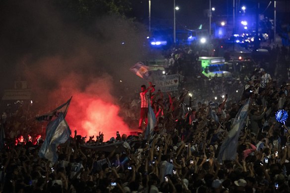 Fans welcome home the players from the Argentine soccer team that won the World Cup after they landed at Ezeiza airport on the outskirts of Buenos Aires, Argentina.