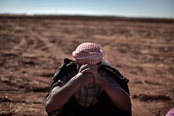A refugee from the Syrian town of Ain al-Arab, known as Kobane by the Kurds, rests after crossing the Turkish border with Syria near the city of Sanliurfa on October 4, 2014. Photo by AFP