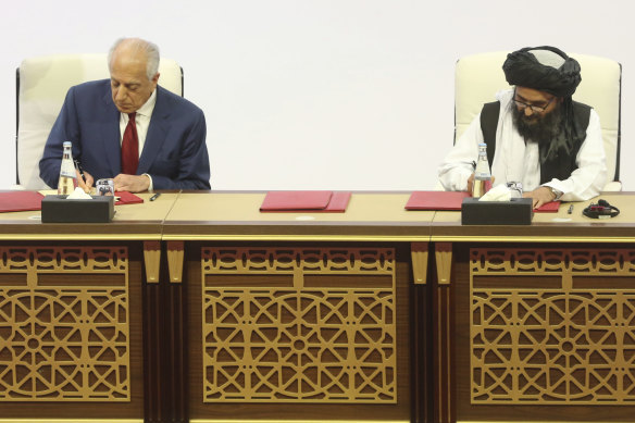 US peace envoy Zalmay Khalilzad, left, and Mullah Abdul Ghani Baradar, the Taliban group's top political leader sign a peace agreement.