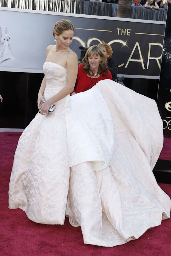 Jennifer Lawrence, best actress nominee for "Silver Linings Playbook," wears a white Dior Haute Couture dress as she arrives at the 85th Academy Awards in Hollywood.