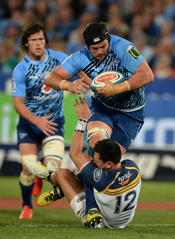 Flip van der Merwe of the Bulls is tackled by Christian Lealiifano.