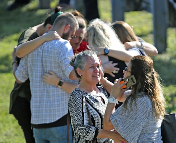 People gather waiting for word from students at a Florida high school.