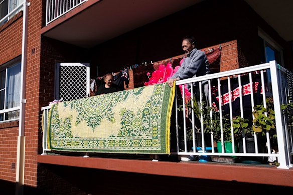 Anna Adams who has lived in her Punchbowl flat for 20 years, with her daughter, "Skinny", who is helping her mother spring clean, during lockdown in Sydney. The Canterbury-Bankstown LGA considered a hotspot and under tighter restrictions.