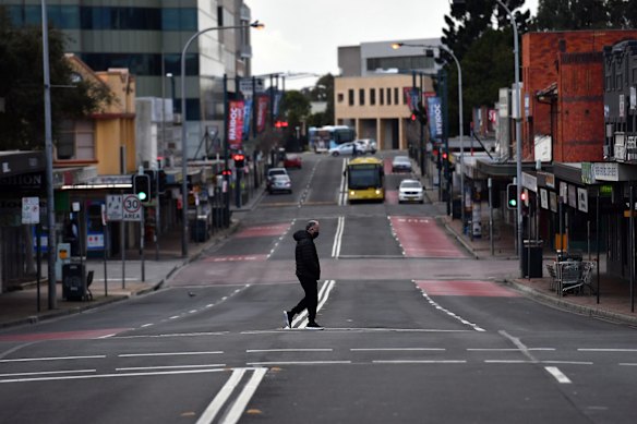 Shoppers walk on Moore Street in Liverpool, as COVID restrictions tighten across Sydney.