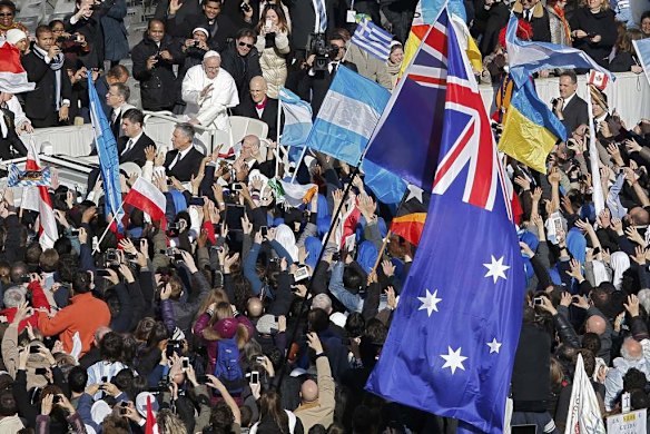 Pope Francis passes an Australian flag as he arrives in Saint Peter's Square for his inaugural mass.