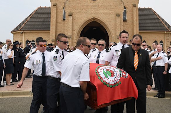 RFS crew members from Horsley Park RFS carry the casket of NSW RFS volunteer Andrew ODwyer during his funeral service.