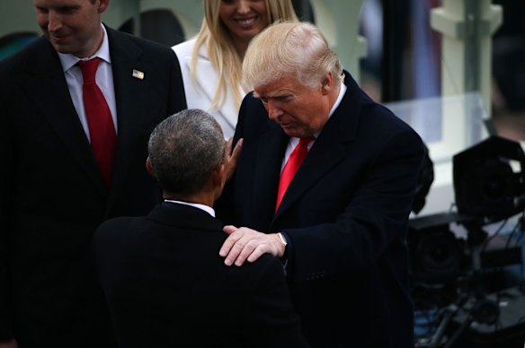 U.S. President Donald Trump, right, greets former U.S. President Barack Obama during the 58th presidential inauguration in Washington, D.C., U.S., on Friday, Jan. 20, 2017. Donald Trump will become the 45th president of the United States today, in a celebration of American unity for a country that is anything but unified. Photographer: Daniel Acker/Bloomberg