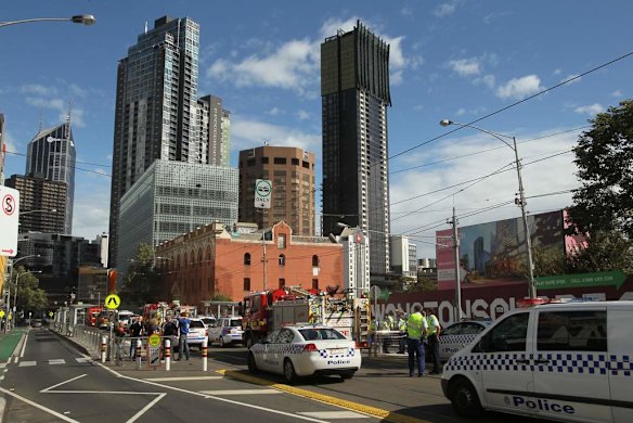Firemen and workers with bare hands frantically remove the fallen bricks.
