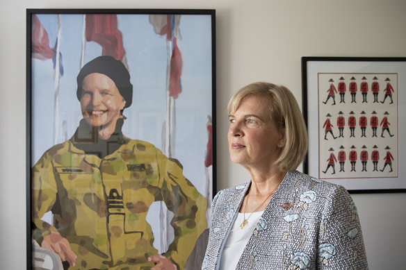 Jennifer Wittwer, gender advisor and former member of the Royal Australian Navy, with a textile portrait of herself by artist Lucy Sattler.
