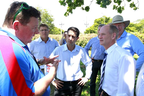 Premier Campbell Newman and David Crisafulli MP talk to a local about a new stadium for Townsville.