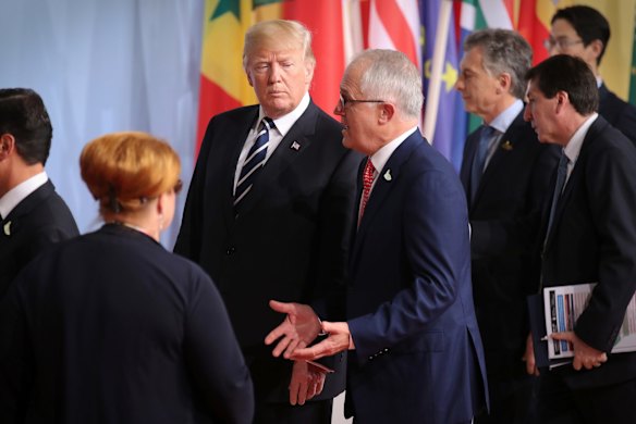 Australian Prime Minister Malcolm Turnbull walks with US President Donald Trump to the family photo during the G20 Summit in Hamburg, Germany.