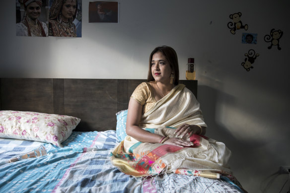 Himali Nayak sits on her bed in her Westmead apartment. 