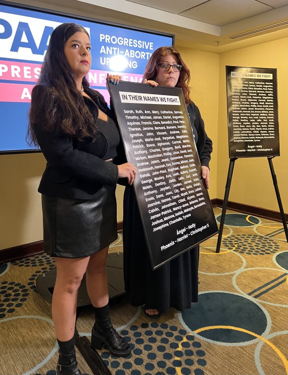 Anti-abortion activists Terrisa Bukovinac and Lauren Handy holding up the names they had given to 110 aborted fetuses they say they “recovered” from a waste truck in Washington last week.
