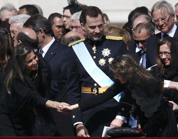 Princess Maxima (left) of the Netherlands offers the sign of peace with Spain's Princess Letizia near Prince Felipe during the inaugural mass of Pope Francis.