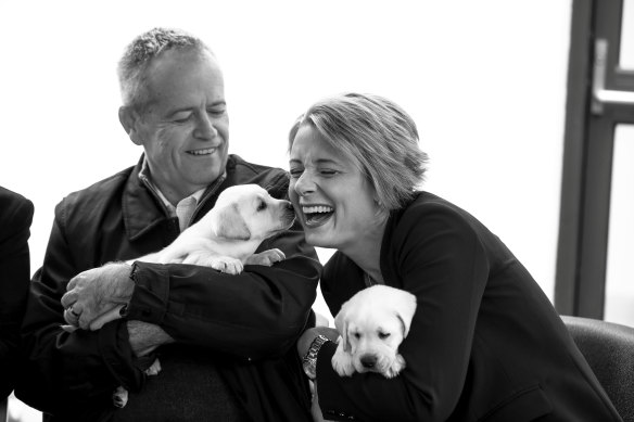 Bill Shorten meets puppies with Labor senator Kristina Keneally.