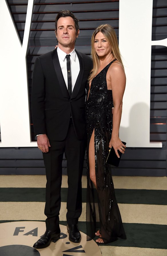 Justin Theroux and Jennifer Aniston in Versace at the Vanity Fair party.
