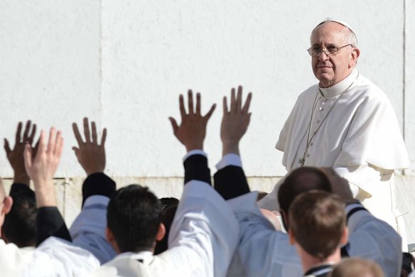 Priests and seminarists wave to Pope Francis during his inauguration mass.