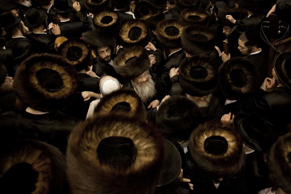 Ultra-Orthodox Jewish men gather at a yeshiva, a rabbinical seminary.