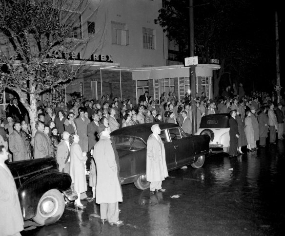 A crowd gathers outside the Rex Hotel in Kings Cross during a fire in the Gowrie Gate Flats on 25 September 1954.