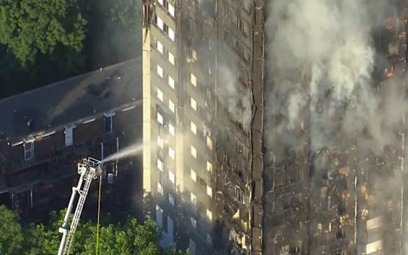 In this photo taken from video, smoke rises from a high-rise apartment building on fire in London, Wednesday, June 14, 2017.