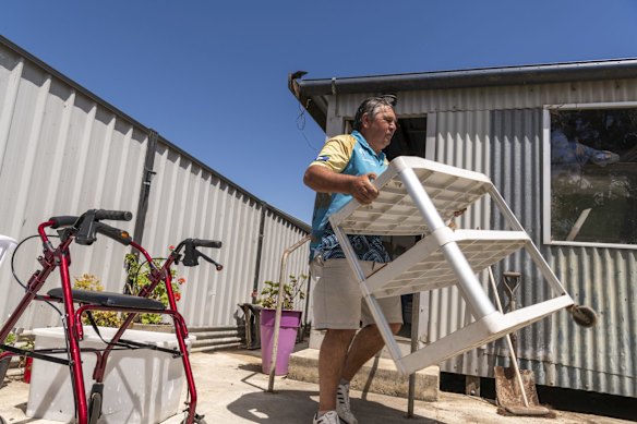 Booraja project manager Bunja Smith, removing waste from Peter Holmes's house in Mogo.