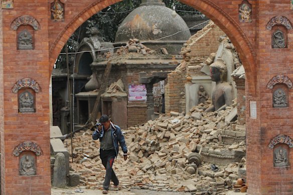 A Nepalese man cries as he walks through the earthquake debris in?Bhaktapur, near Kathmandu, Nepal, Sunday, April 26, 2015. 