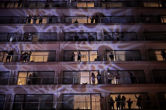 Guests at the Pullman Hotel, which ran a silent balcony New Year's party, welcome in 2021 near the Eiffel Tower in Paris, France. 