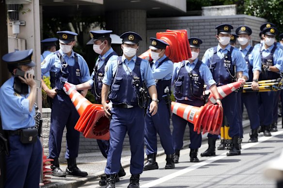 Police officers stand guard in front of Abe's home in Tokyo, Japan.