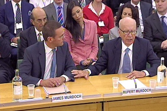 Rupert Murdoch, right, and his son James speak to the committee.