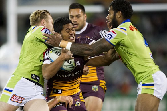 Anthony Milford of the Brisbane Broncos tackled by Radiers Defence.