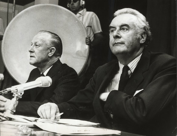 “Australia’s temporary two-man Government at a press conference in Canberra yesterday: The Prime Minister, Mr Whitlam (foreground), who holds 13 portfolios and the Deputy Prime Minister, Mr Barnard, who holds 14 portfolios.”