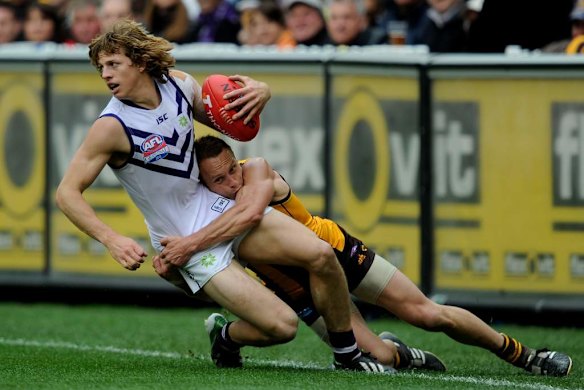 Hawthorn's Brad Sewell tackles Nathan Fyfe.