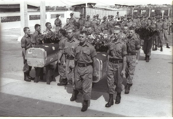 Australian pallbearers carry the coffins of three of their Ist Battalion comrades into a chapel for a memorial service in Saigon. The soldiers were killed in the June 26 incident. 