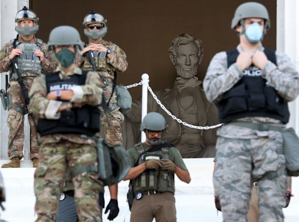 Members of the D.C. National Guard stand on the steps of the Lincoln Memorial monitoring demonstrators during a peaceful protest against police brutality in Washington, DC on Tuesday.