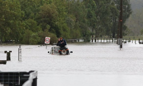 Two people trapped on their 4wd in flood waters at Woodville on Paterson rd.