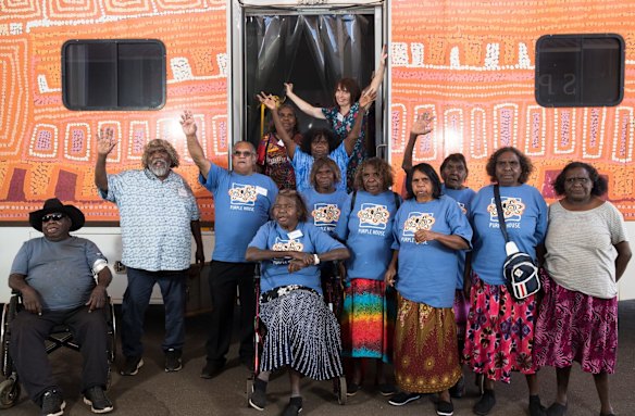 Directors of Purple House with their bus that travels to remote communities to give patients dialysis on board, in Alice Springs.
