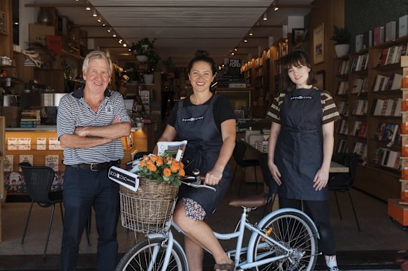 Ray Bonner of Bookoccino, with two employees Manea and Jessis, home delivering books for people who don't want to go into the store and are prepping for lockdown. 
